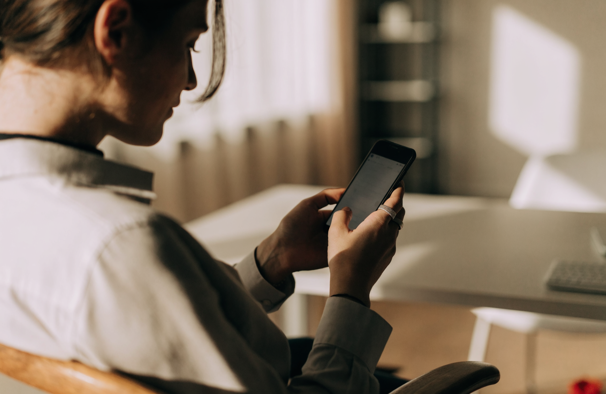 An independent professional checking their schedule on a phone