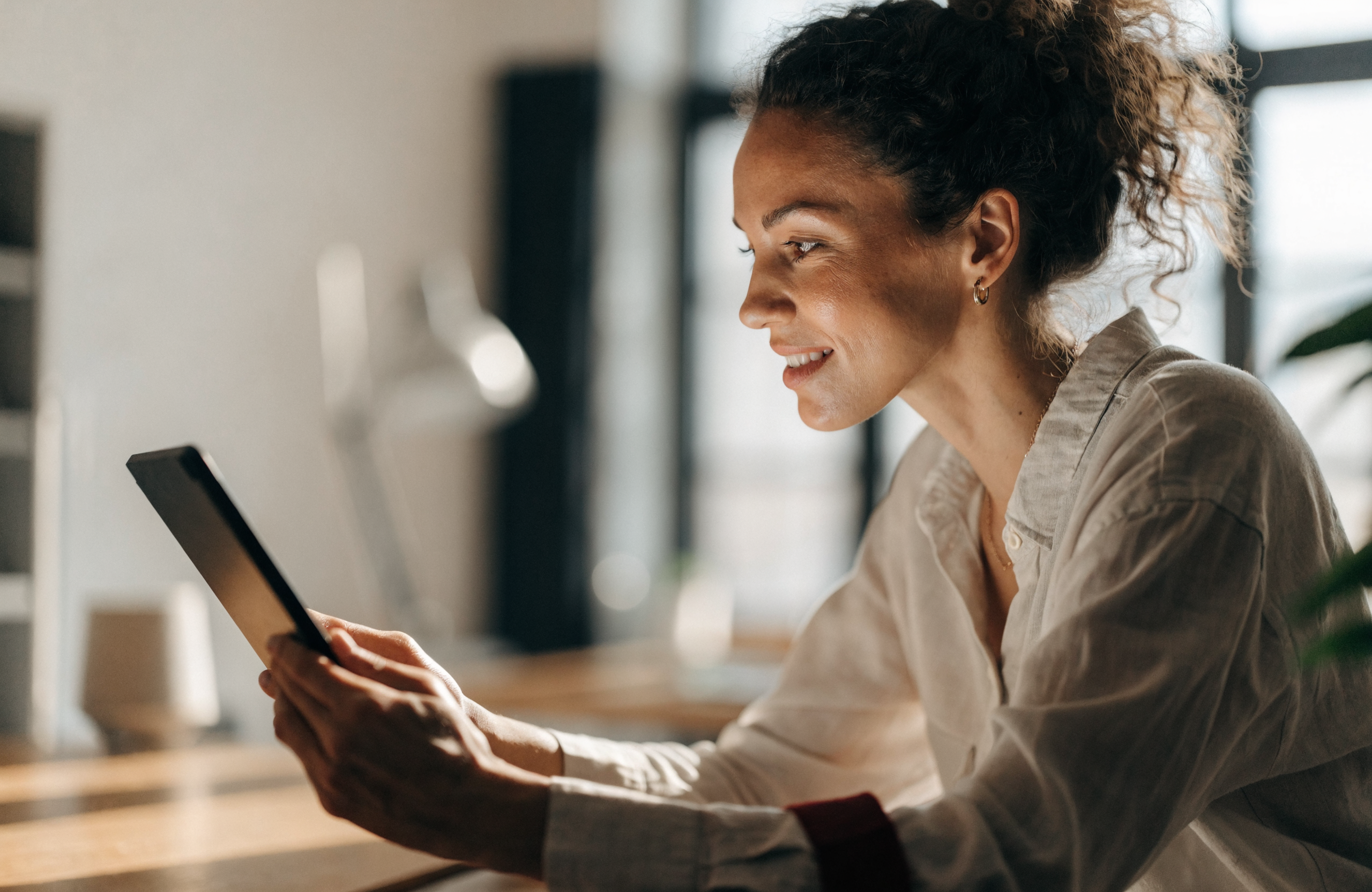 A professional reviewing business growth on a tablet